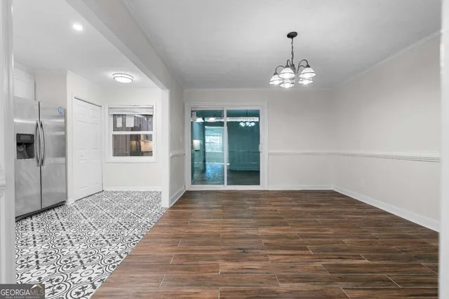 a view of a room with wooden floor