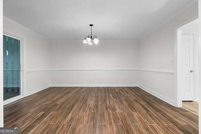 a view of kitchen with granite countertop cabinets and refrigerator