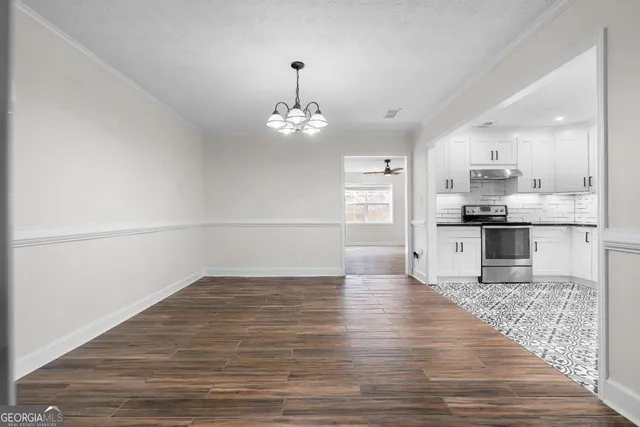 a kitchen with stainless steel appliances granite countertop a refrigerator a sink a stove a microwave and cabinets