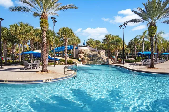 a view of a swimming pool with a table and chairs