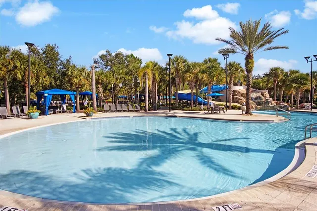 a view of a swimming pool with outdoor seating