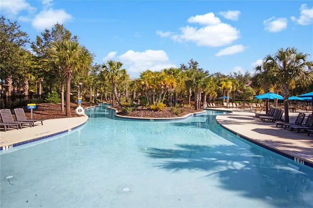 a view of a swimming pool with an outdoor seating
