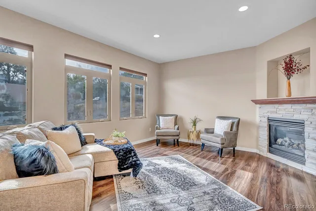 a living room with furniture and a fireplace
