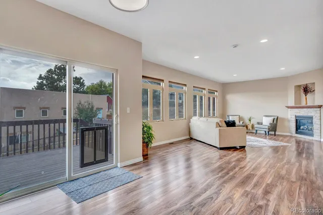 a living room with furniture and a floor to ceiling window