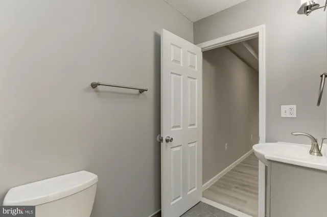 a bathroom with a toilet a sink and mirror