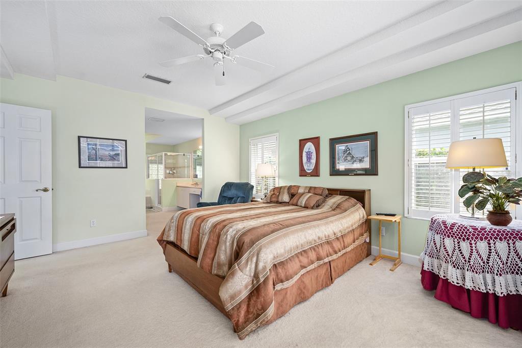 8 Gale Lane Ormond Beach, FL 32174 - Photo 27 of 77 a bedroom with a bed and a chandelier