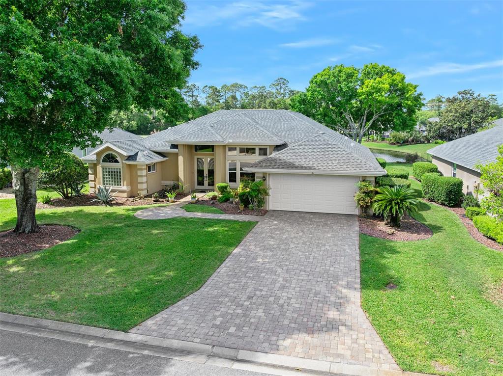 8 Gale Lane Ormond Beach, FL 32174 - Photo 4 of 77 a front view of a house with a garden and trees