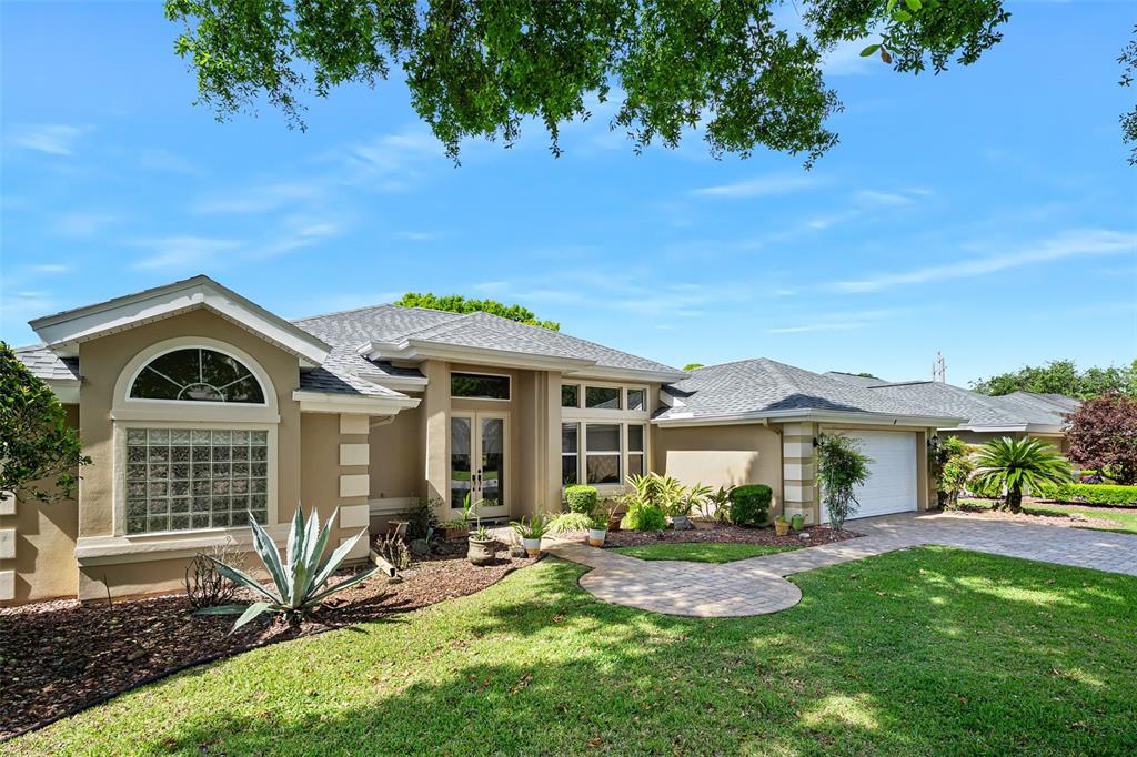 8 Gale Lane Ormond Beach, FL 32174 - Photo 7 of 77 a front view of a house with a garden