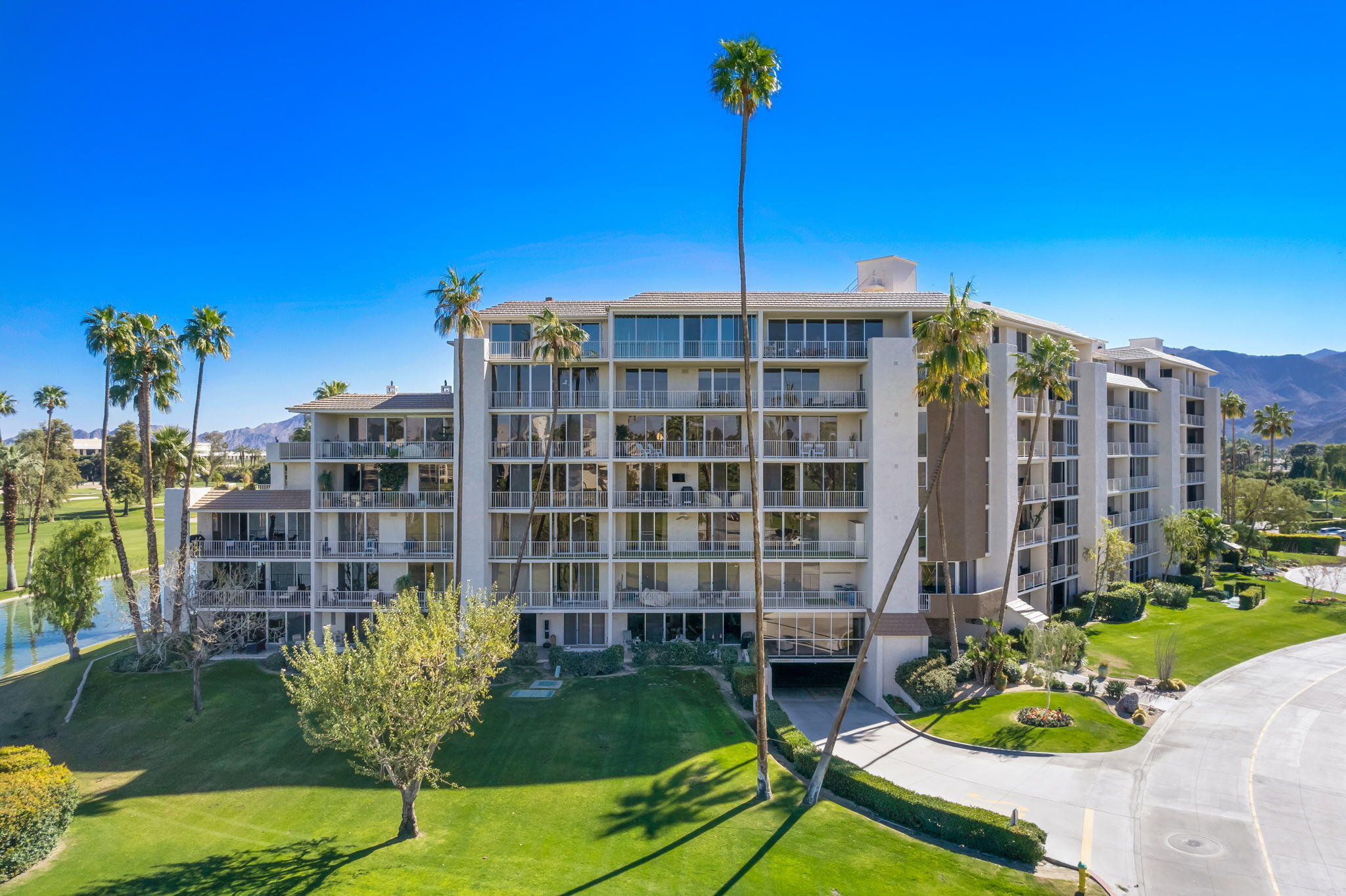 900 Island Drive, Unit 304 Rancho Mirage, CA 92270 - Photo 1 of 27 a front view of a house with a garden