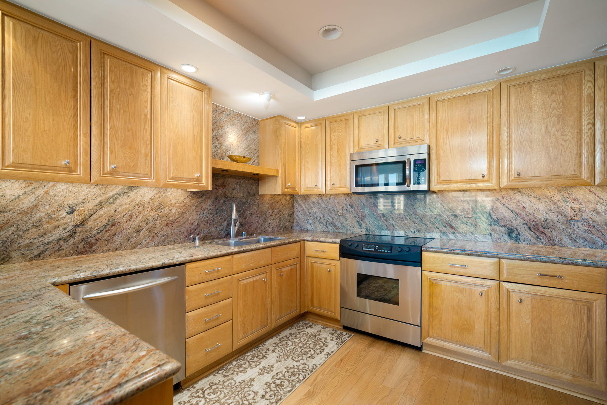 900 Island Drive, Unit 304 Rancho Mirage, CA 92270 - Photo 14 of 27 a kitchen with stainless steel appliances granite countertop a stove a sink and a microwave