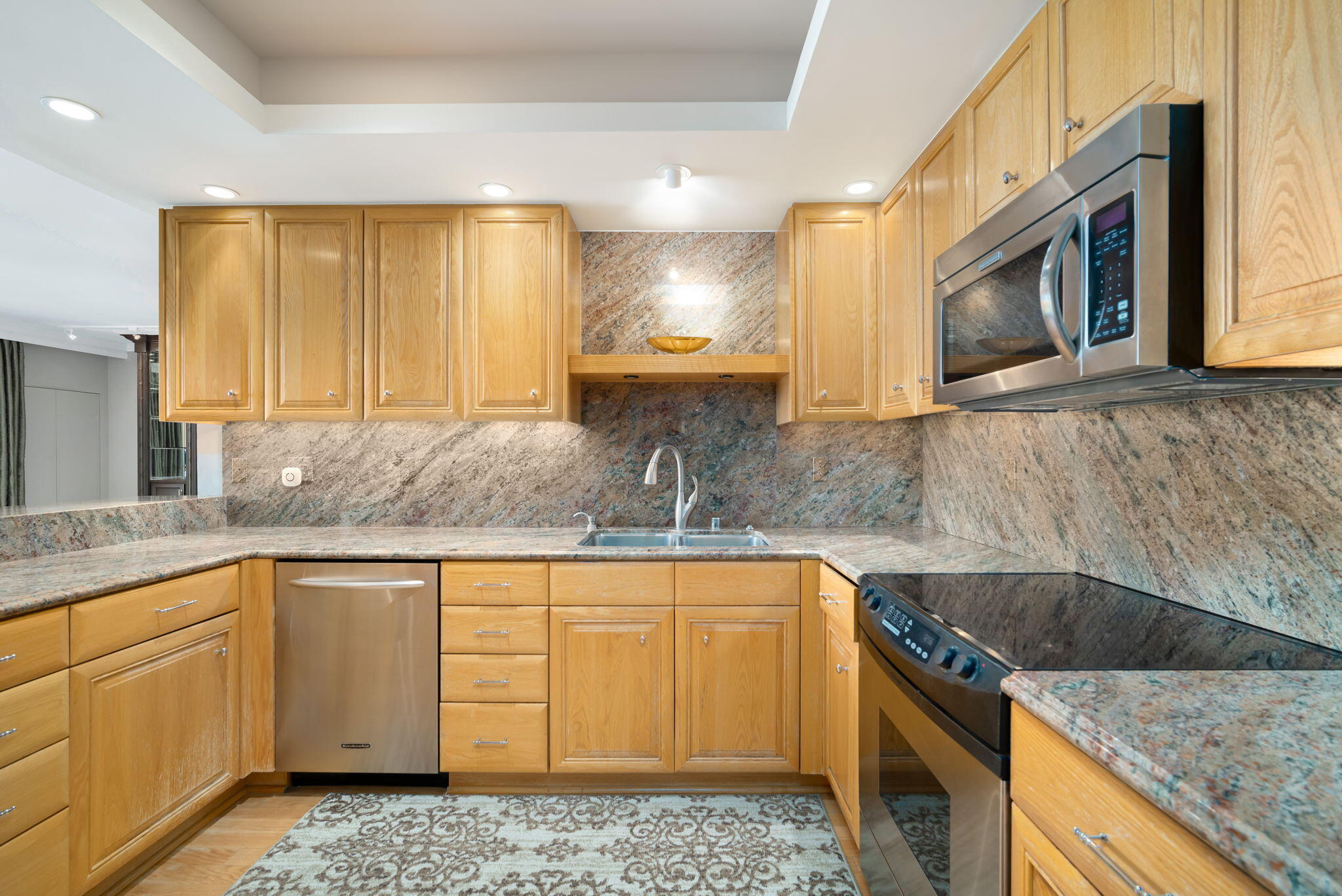 900 Island Drive, Unit 304 Rancho Mirage, CA 92270 - Photo 15 of 27 a kitchen with stainless steel appliances granite countertop a sink stove and cabinets