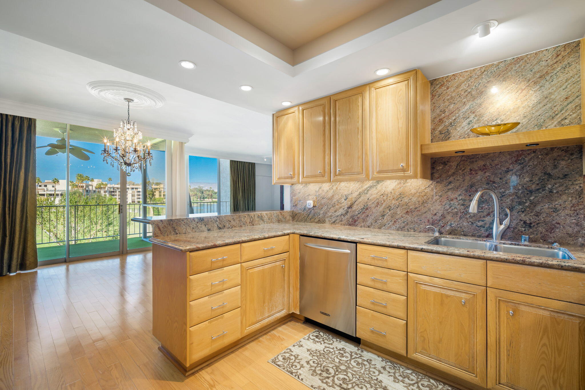 900 Island Drive, Unit 304 Rancho Mirage, CA 92270 - Photo 16 of 27 a kitchen with granite countertop a sink and cabinets