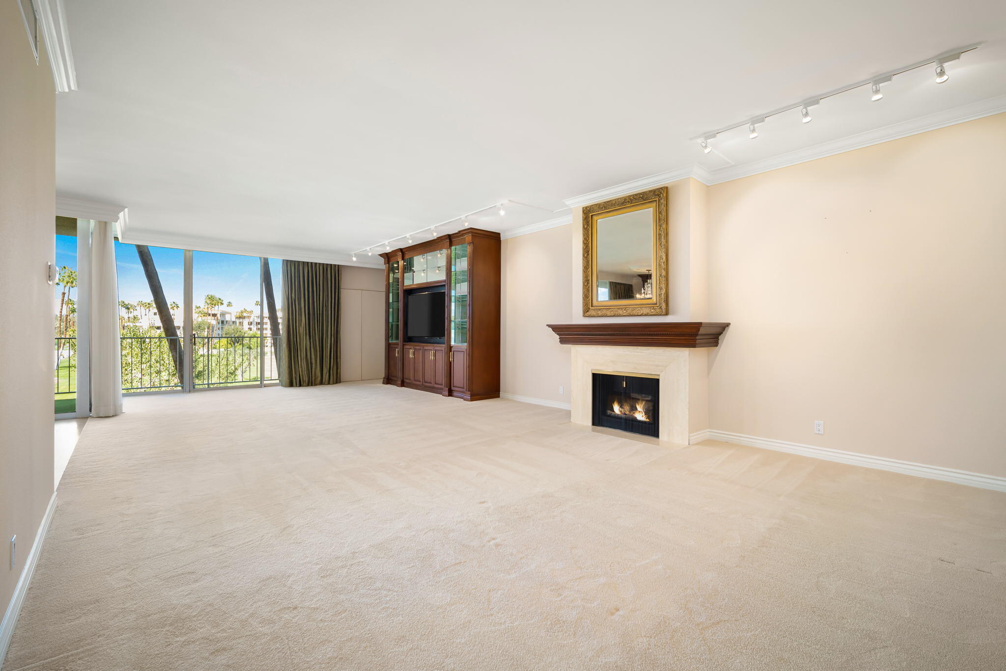 900 Island Drive, Unit 304 Rancho Mirage, CA 92270 - Photo 4 of 27 a big room with windows and a fireplace