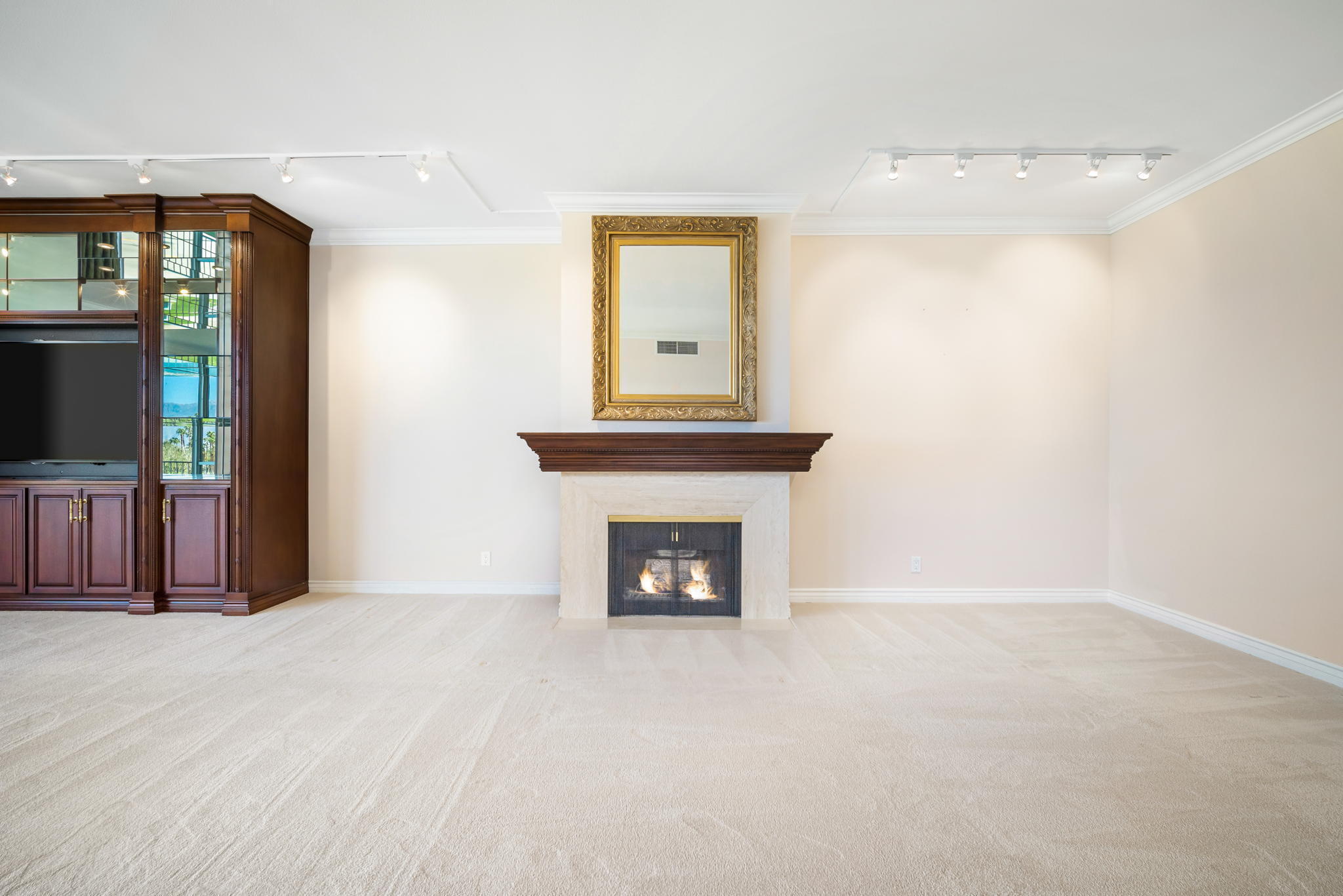 900 Island Drive, Unit 304 Rancho Mirage, CA 92270 - Photo 6 of 27 a view of an empty room with wooden floor and a fireplace