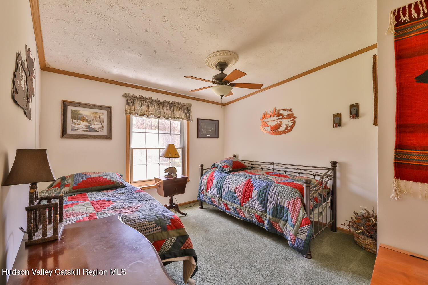 751 Mitchell Hollow Road Windham, NY 12496 - Photo 24 of 37 a bedroom with a bed and a chandelier