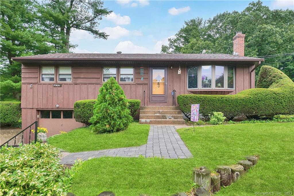 634 Old Post Road Tolland, CT 06084 - Photo 1 of 1 a front view of a house with a yard table and chairs