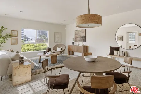 a view of a dining room with furniture and a window