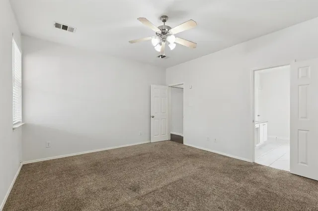 a view of a chandelier fan in big room