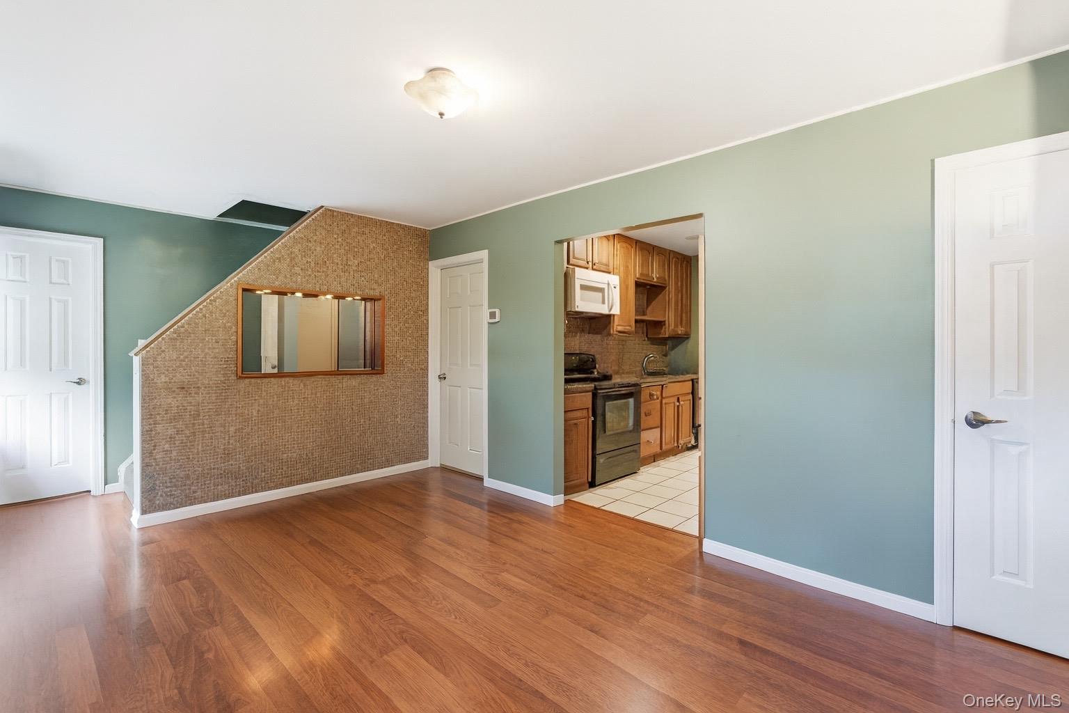 36 Ralph Avenue Brentwood, NY 11717 - Photo 6 of 23 a view of a livingroom with wooden floor
