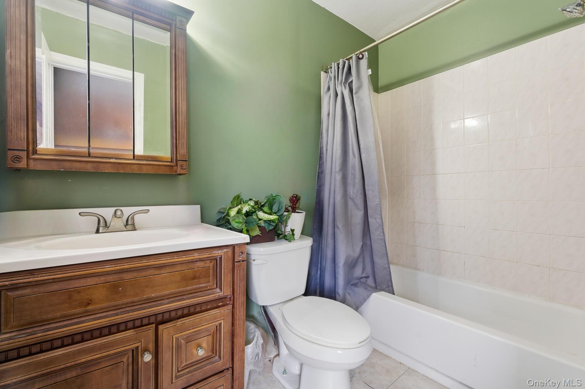 36 Ralph Avenue Brentwood, NY 11717 - Photo 10 of 23 a bathroom with a sink toilet and shower