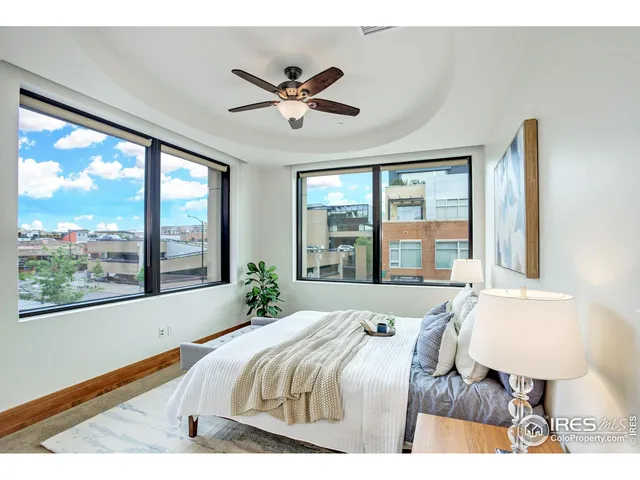 a bedroom with a bed and lamp