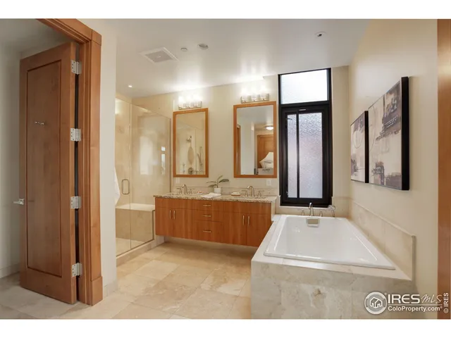 a bathroom with double vanity sinks and a mirror