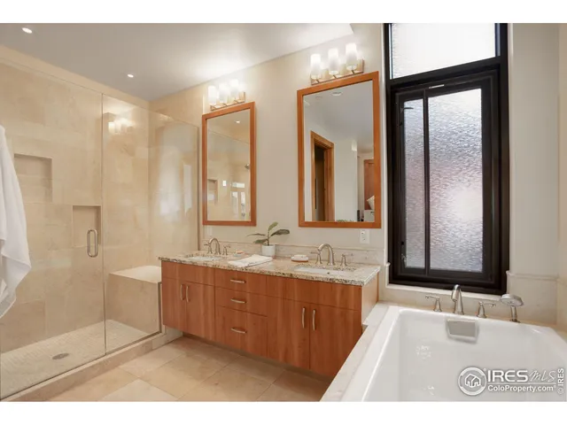 a bedroom with two beds and a ceiling fan