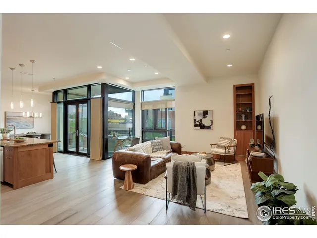 a living room with furniture a flat screen tv and a large window
