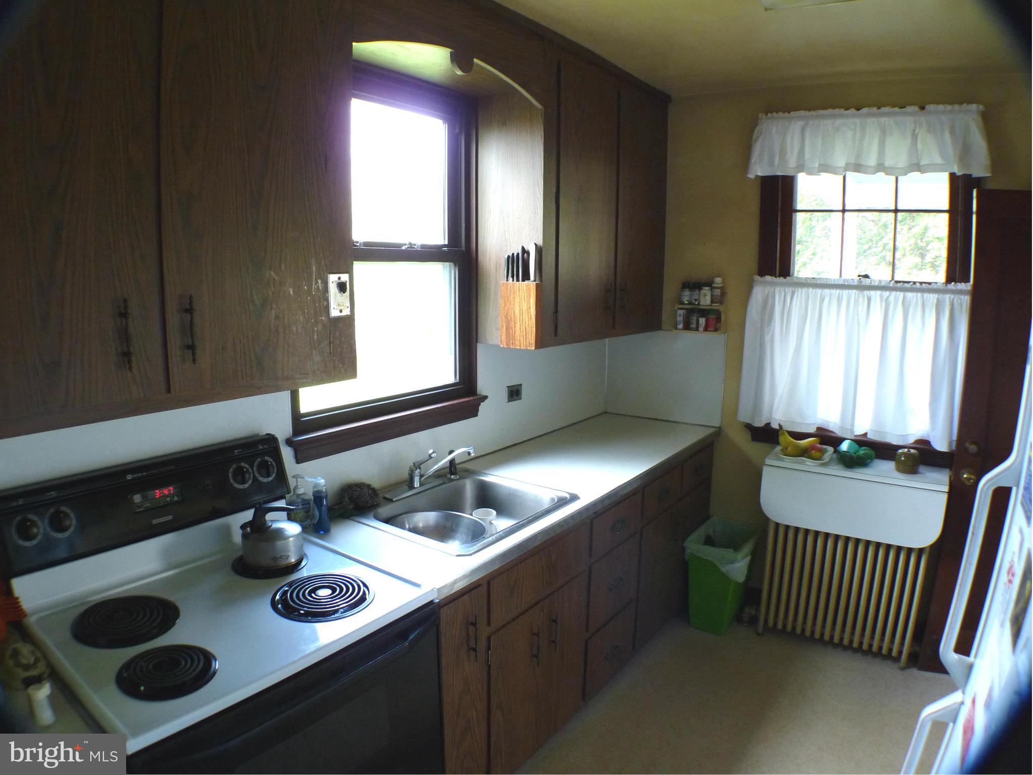 2600 Briggs Chaney Road Silver Spring, MD 20905 - Photo 7 of 20 a kitchen with a window sink and cabinets
