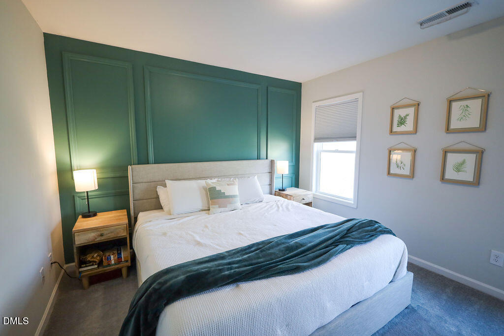 230 South Raleigh Street Angier, NC 27501 - Photo 25 of 38 a bedroom with a bed and a table