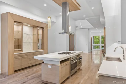 a kitchen that has a sink a stove and a window