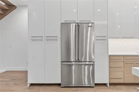 a view of kitchen with stainless steel appliances wooden floor