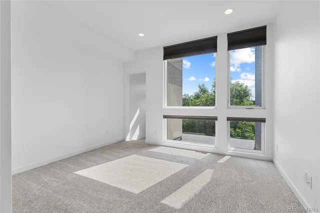 an empty room with windows and yard