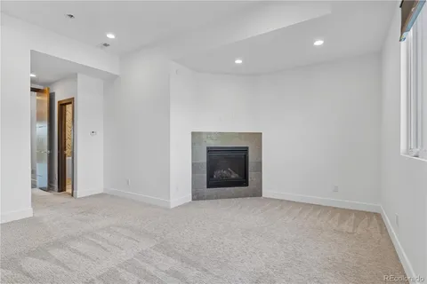 a view of an empty room with a fireplace