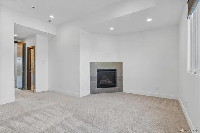 a view of an empty room with a fireplace