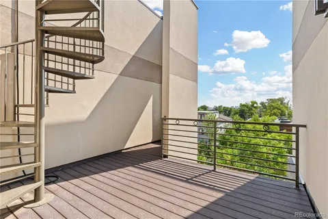 a view of a balcony with wooden floor