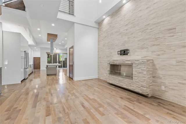 a view of a hallway with wooden floor and a fireplace