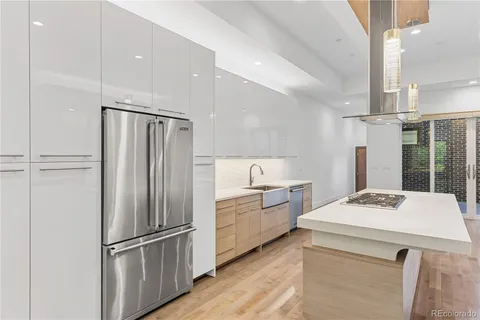 a kitchen with a refrigerator a stove a sink and a refrigerator