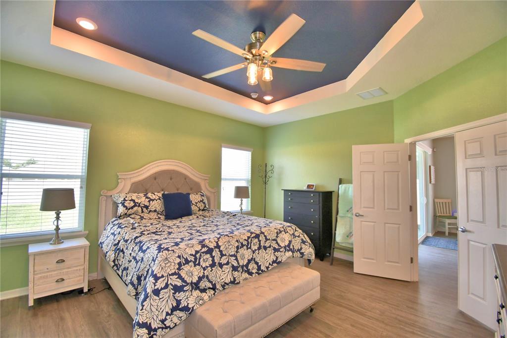 4340 Reding Way Lakeland, FL 33813 - Photo 42 of 63 a bedroom with a large bed and a chandelier