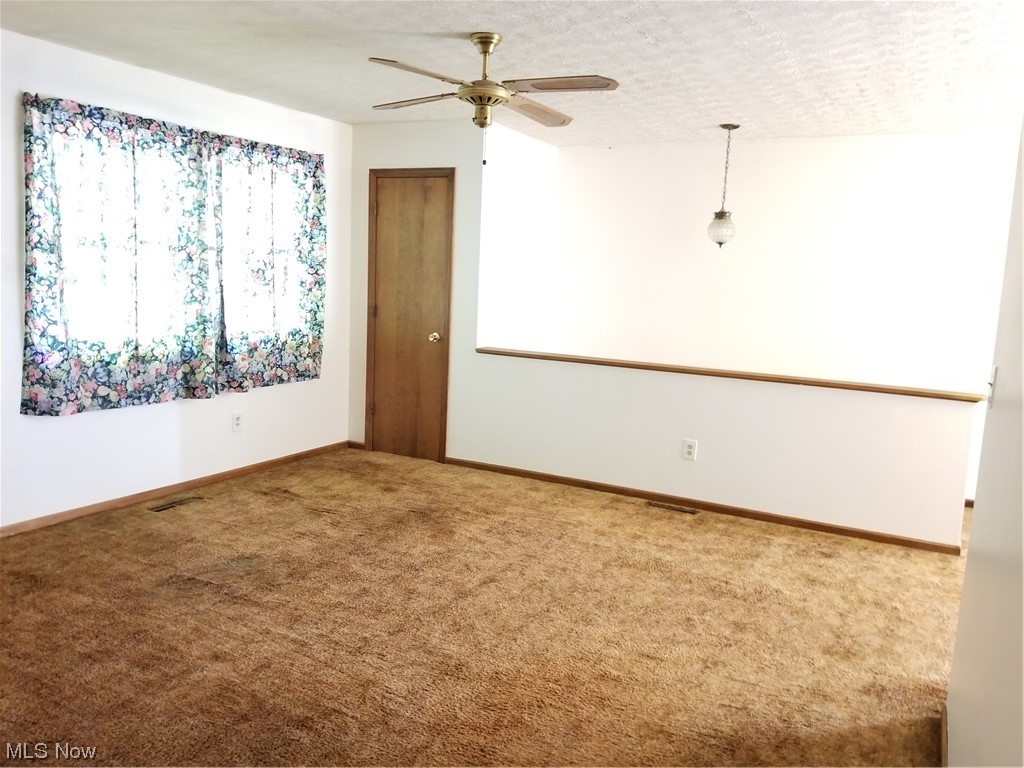 756 Cunningham Road Salem, OH 44460 - Photo 8 of 25 Carpeted spare room with lofted ceiling and ceiling fan