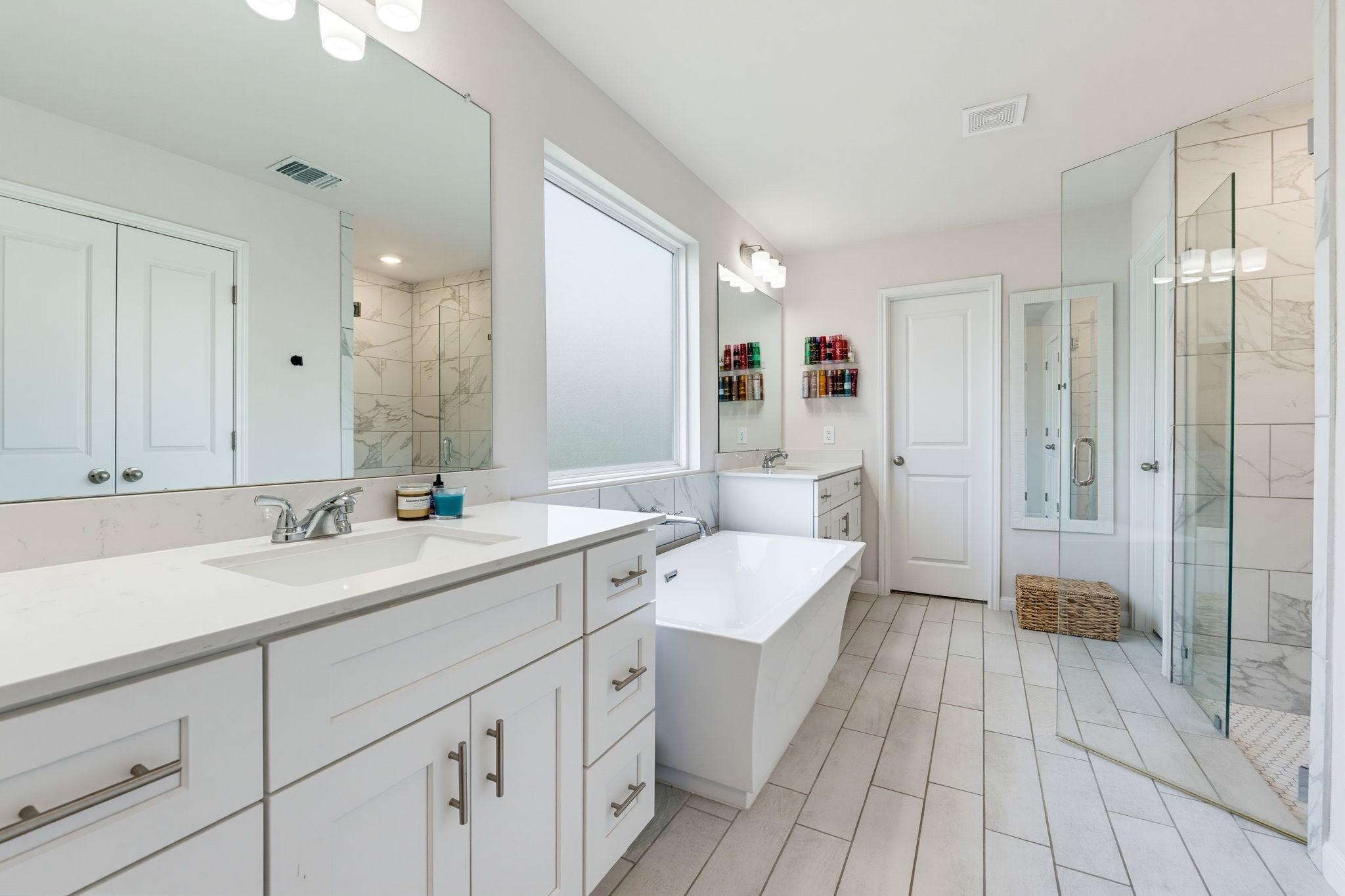 316 Windstar Road Liberty Hill, TX 78642 - Photo 16 of 27 a spacious bathroom with a double vanity sink mirror and shower
