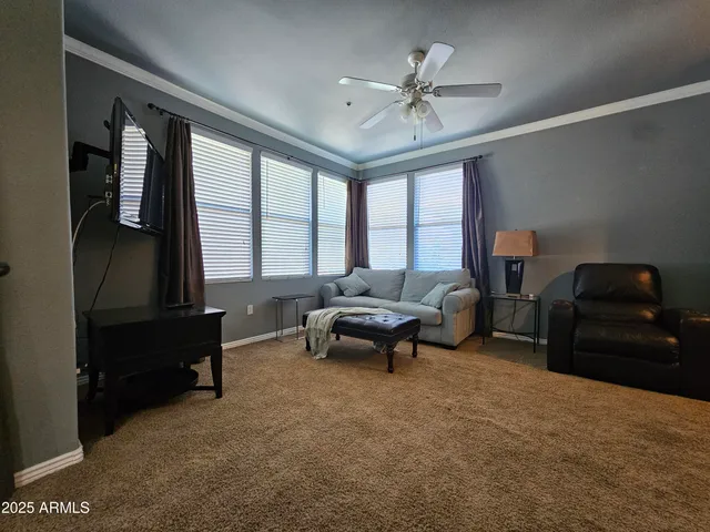 a living room with furniture and a large window