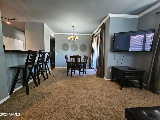 a view of a livingroom with furniture and a flat screen tv