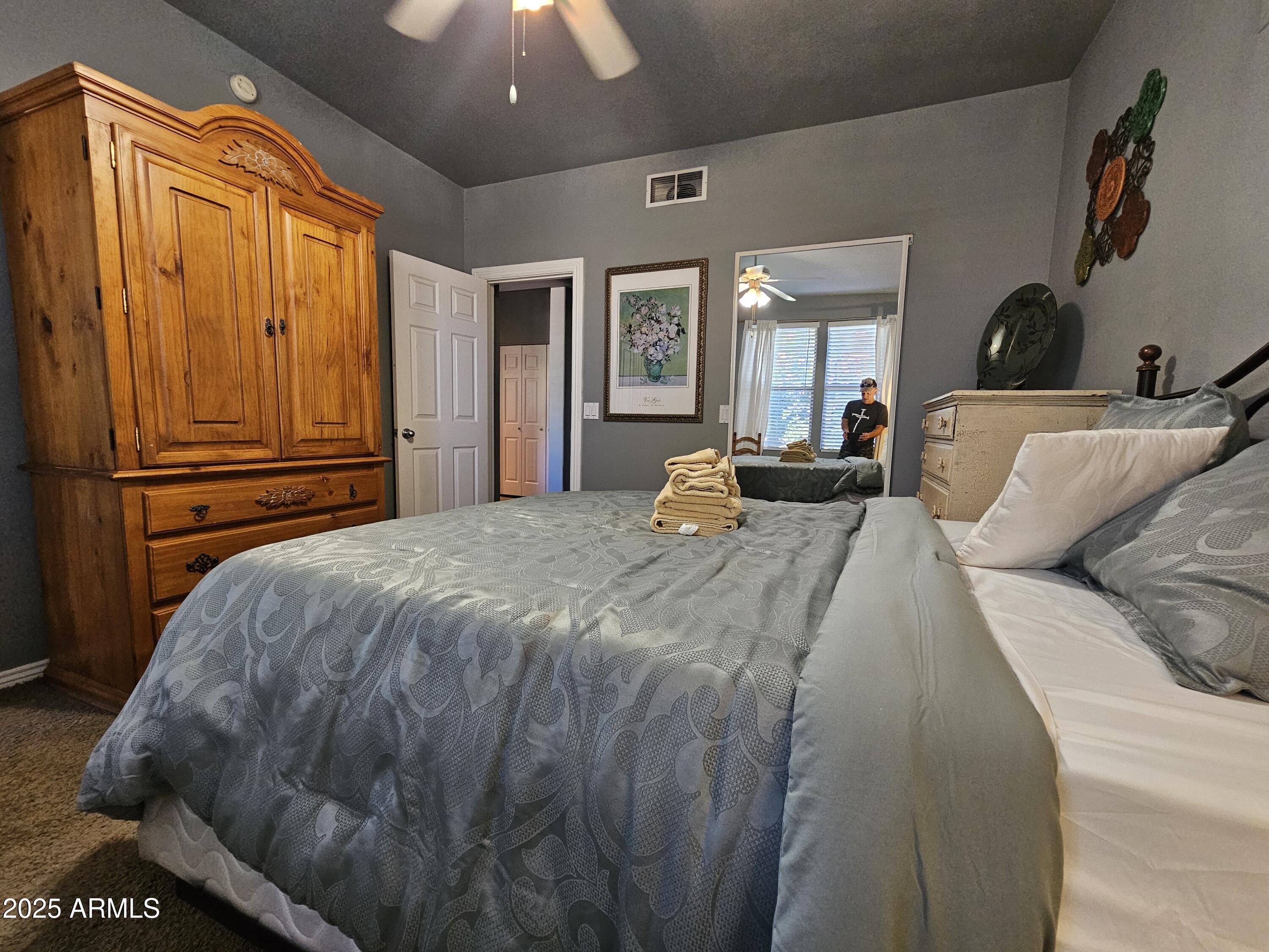 20100 North 78th Place, Unit 2180 Scottsdale, AZ 85255 - Photo 6 of 16 a bed sitting in a bedroom next to a window