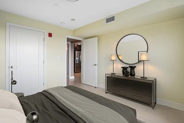 a bedroom with a bed and a dresser