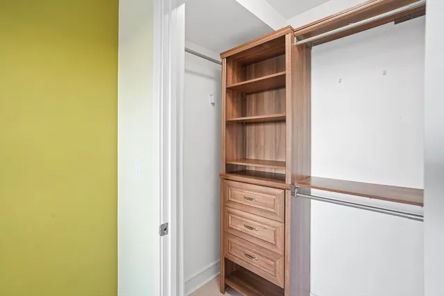 a view of walk in closet with empty racks