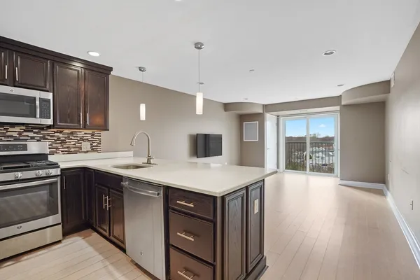 a kitchen with a stove a sink and a microwave