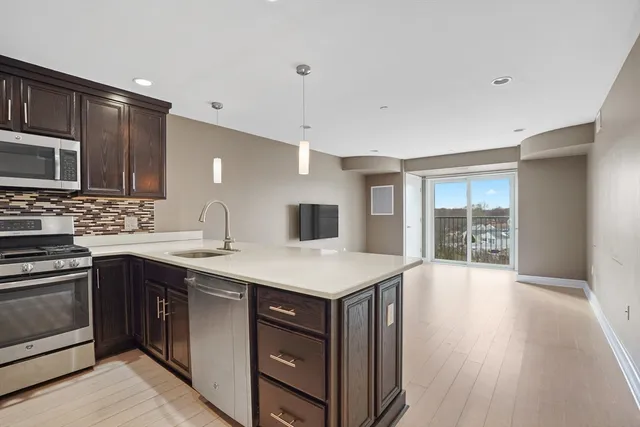a kitchen with a stove a sink and a microwave
