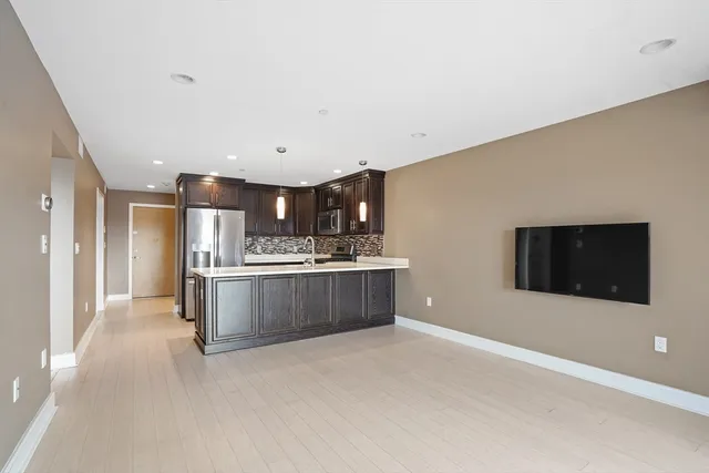 a kitchen with stainless steel appliances kitchen island sink and cabinets