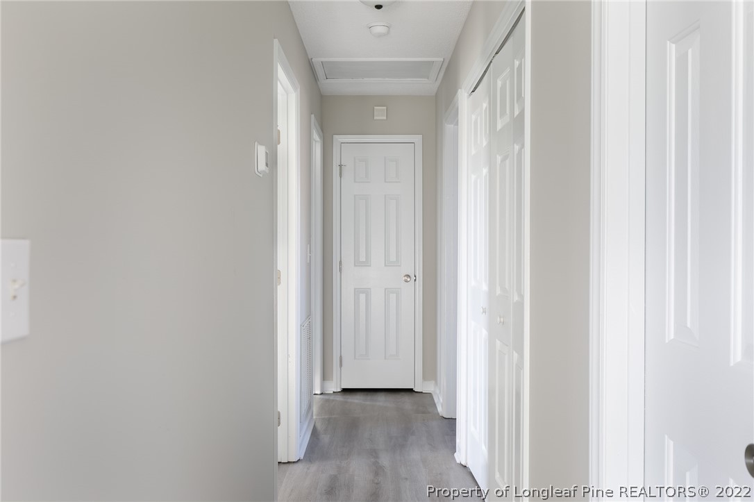 1119 Live Oak Road Coats, NC 27521 - Photo 11 of 23 a view of a hallway with wooden floor